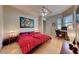 Bedroom with wood floors, a ceiling fan, a workspace, and bright decor at 2064 Poetry Ave, Henderson, NV 89052