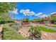 Scenic community entrance with water feature, lush landscaping, and beautiful desert scenery at 2064 Poetry Ave, Henderson, NV 89052