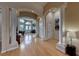 Inviting foyer featuring hardwood floors, white columns, archways, and a view into the living spaces at 2064 Poetry Ave, Henderson, NV 89052