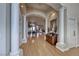 Grand foyer with hardwood floors, white columns, archways, and views into the dining and living rooms at 2064 Poetry Ave, Henderson, NV 89052