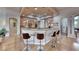 Bright and airy kitchen featuring a breakfast bar, modern appliances, and seamless access to dining and living areas at 2064 Poetry Ave, Henderson, NV 89052