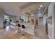 Spacious open kitchen with a breakfast bar, stainless steel appliances, and seamless flow to the living room at 2064 Poetry Ave, Henderson, NV 89052