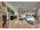 Living room features hardwood flooring, modern fireplace and open access to kitchen at 2064 Poetry Ave, Henderson, NV 89052