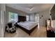 Spacious main bedroom features hardwood floors, a ceiling fan, and a view of the outdoor space at 2064 Poetry Ave, Henderson, NV 89052