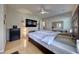 Bright main bedroom with hardwood floors, fan, and a large headboard, creating a welcoming retreat at 2064 Poetry Ave, Henderson, NV 89052