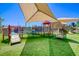 A bright and colorful playground with various play structures and soft, artificial turf for community enjoyment at 2064 Poetry Ave, Henderson, NV 89052