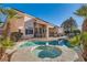 Backyard retreat featuring a pool, spa, and outdoor seating, surrounded by lush landscaping at 225 Deer Crossing Way, Henderson, NV 89012