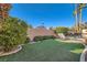 Private backyard with well-maintained artificial turf, lounge chairs, and desert landscaping at 225 Deer Crossing Way, Henderson, NV 89012