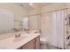 Bright bathroom with a single vanity, shower-tub combo and tile floors at 225 Deer Crossing Way, Henderson, NV 89012