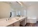 Bright bathroom with double sinks, a large mirror, and a separate tub and shower at 225 Deer Crossing Way, Henderson, NV 89012