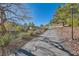 Community path with lush landscaping, mature trees, and a sidewalk to encourage walking and exercise at 225 Deer Crossing Way, Henderson, NV 89012