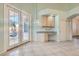 Bright dining area featuring French doors, tile flooring, and a built-in desk with cabinetry at 225 Deer Crossing Way, Henderson, NV 89012