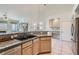 Spacious kitchen featuring granite countertops, stainless appliances, breakfast bar, and open layout at 225 Deer Crossing Way, Henderson, NV 89012