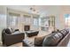 Cozy living room featuring a fireplace, comfortable seating, and natural light from large windows at 225 Deer Crossing Way, Henderson, NV 89012