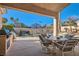 Outdoor patio with dining and barbecue area, overlooking the fenced pool at 225 Deer Crossing Way, Henderson, NV 89012