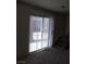 Living room with sliding doors, carpet, and stairs at 2290 Desert Inn, Las Vegas, NV 89169