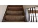 Carpeted staircase with dark wood trim and black iron railing at 2290 Desert Inn, Las Vegas, NV 89169