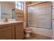 Bathroom with a sliding glass door shower and neutral vanity with a pink toilet at 2456 Desert Sands Dr, Las Vegas, NV 89134