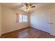 Bedroom with hardwood floors, ceiling fan, closet with sliding doors and large window at 2456 Desert Sands Dr, Las Vegas, NV 89134