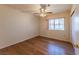 Bedroom with hardwood floors, ceiling fan, and large window overlooking the front yard at 2456 Desert Sands Dr, Las Vegas, NV 89134