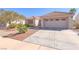 Charming single-story home with a well-maintained desert-style front yard and attached two-car garage at 2456 Desert Sands Dr, Las Vegas, NV 89134