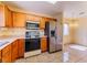 Efficient kitchen with stainless steel refrigerator, tile floors, and built-in microwave at 2456 Desert Sands Dr, Las Vegas, NV 89134