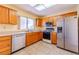 Functional kitchen with stainless steel appliances, light wood cabinets, and tile floors at 2456 Desert Sands Dr, Las Vegas, NV 89134