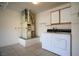 Laundry room with white washer and dryer, white cabinets, and tile floors at 2456 Desert Sands Dr, Las Vegas, NV 89134