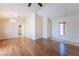 Spacious living room featuring gleaming hardwood floors and a decorative light fixture at 2456 Desert Sands Dr, Las Vegas, NV 89134