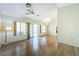 Bright living room with hardwood floors, ceiling fan, and a sliding door to the backyard at 2456 Desert Sands Dr, Las Vegas, NV 89134