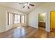 Spacious main bedroom with hardwood floors, ceiling fan, and bay window overlooking the backyard at 2456 Desert Sands Dr, Las Vegas, NV 89134