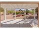 Covered patio offering a peaceful view of the desert-style backyard with natural greenery at 2456 Desert Sands Dr, Las Vegas, NV 89134