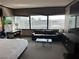 Bedroom area with a sofa and large windows showcasing the expansive city views at 2600 W Harmon Ave # 25019, Las Vegas, NV 89158