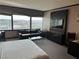 Spacious bedroom with a sofa, city views, and an entertainment center with a large television at 2600 W Harmon Ave # 25019, Las Vegas, NV 89158