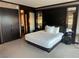 Modern bedroom featuring a king-size bed with white linens and dark wood accents and a glimpse into the bathroom at 2600 W Harmon Ave # 25019, Las Vegas, NV 89158