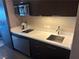 Modern kitchenette area with stainless steel appliances, including a microwave and cooktop at 2600 W Harmon Ave # 25019, Las Vegas, NV 89158