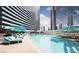Large pool with plenty of seating and sun umbrellas for all guests to enjoy at 2600 W Harmon Ave # 25019, Las Vegas, NV 89158