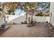 Landscaped back yard with stone pavers, seating area, and mature landscaping at 2632 Starfish Ct, Las Vegas, NV 89128