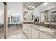 Bathroom with double sinks, granite counters, tile floor, and view into bedroom at 2632 Starfish Ct, Las Vegas, NV 89128