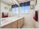 Bathroom featuring a double sink vanity and decorative mirrors at 2632 Starfish Ct, Las Vegas, NV 89128