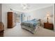 A bright bedroom with plush carpet, ceiling fan, and access to the outdoor patio at 2632 Starfish Ct, Las Vegas, NV 89128