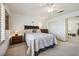 Bright bedroom features neutral colors, a ceiling fan and an open doorway to another room at 2632 Starfish Ct, Las Vegas, NV 89128