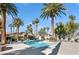 Community pool surrounded by palm trees and lounge chairs at 2632 Starfish Ct, Las Vegas, NV 89128