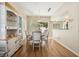 Open dining room with wood floors, a cabinet for storage, and views to the exterior at 2632 Starfish Ct, Las Vegas, NV 89128