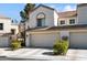 Attractive two-story stucco home with a tile roof, complemented by lush green shrubbery at 2632 Starfish Ct, Las Vegas, NV 89128
