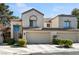 Charming stucco home featuring a tile roof, two-car garage, and manicured landscaping at 2632 Starfish Ct, Las Vegas, NV 89128