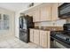 This kitchen features granite counters, an oven range, and a stainless steel refrigerator at 2632 Starfish Ct, Las Vegas, NV 89128