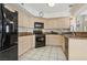 Modern kitchen with black appliances and light colored cabinets at 2632 Starfish Ct, Las Vegas, NV 89128