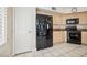 Spacious kitchen featuring stainless steel appliances, granite counters, and tile flooring at 2632 Starfish Ct, Las Vegas, NV 89128