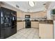 Modern kitchen with black appliances and light colored cabinets at 2632 Starfish Ct, Las Vegas, NV 89128